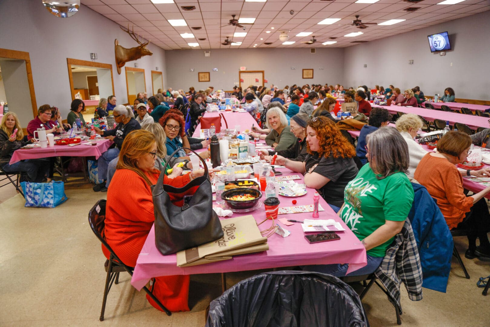 A large group of people sitting at tables in a room.