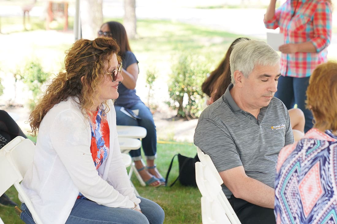 A group of people sitting in chairs at an event.