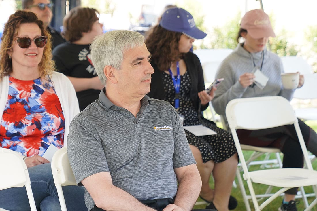 A group of people sitting in chairs at an event.