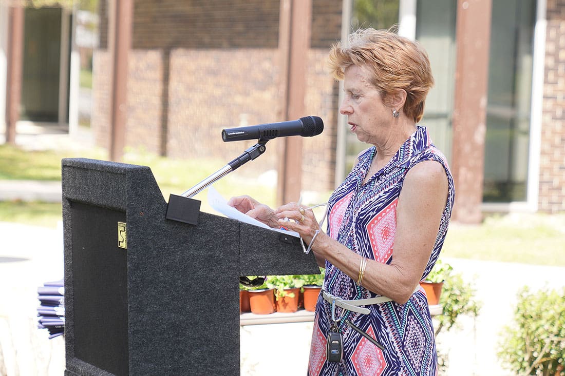 A woman is standing at a podium and giving a speech.