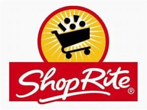 Logo of the community-based Shoprite featuring a black shopping cart with three white circles above it on a yellow sunburst background, with the brand name in red on a red banner below.