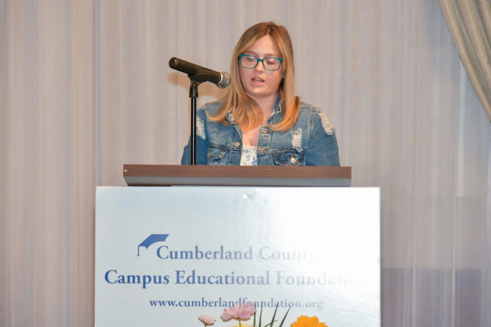 Woman speaking at Cumberland County Campus Educational Center podium.